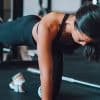 woman going solo and doing yoga pose in open gym