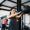 female gym members exercising with kettlebell